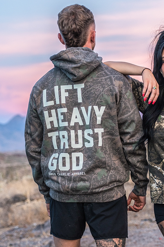 Lift Heavy. Trust God. - Premium Darkwood Camo Hoodie