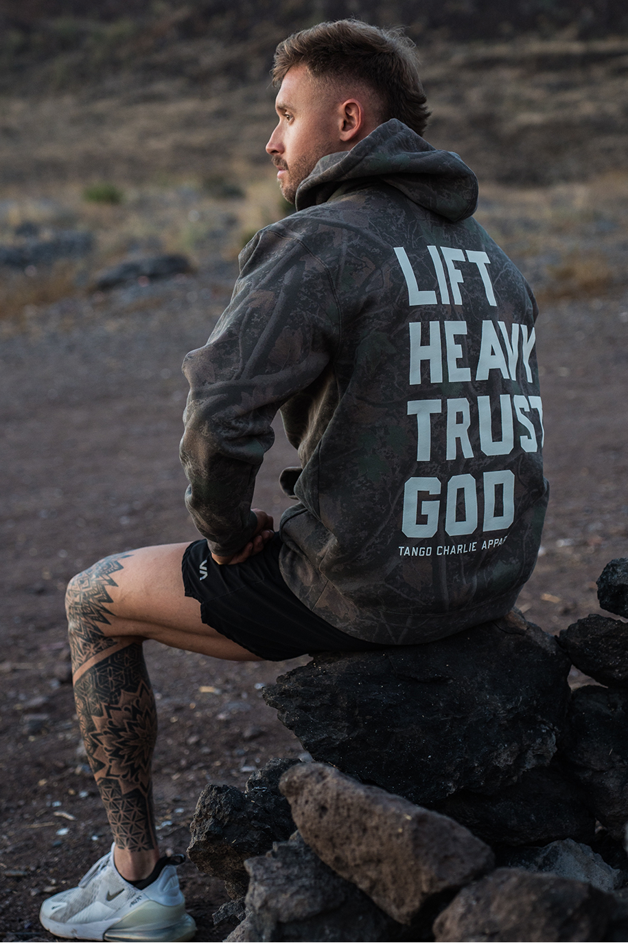 Lift Heavy. Trust God. - Premium Darkwood Camo Hoodie