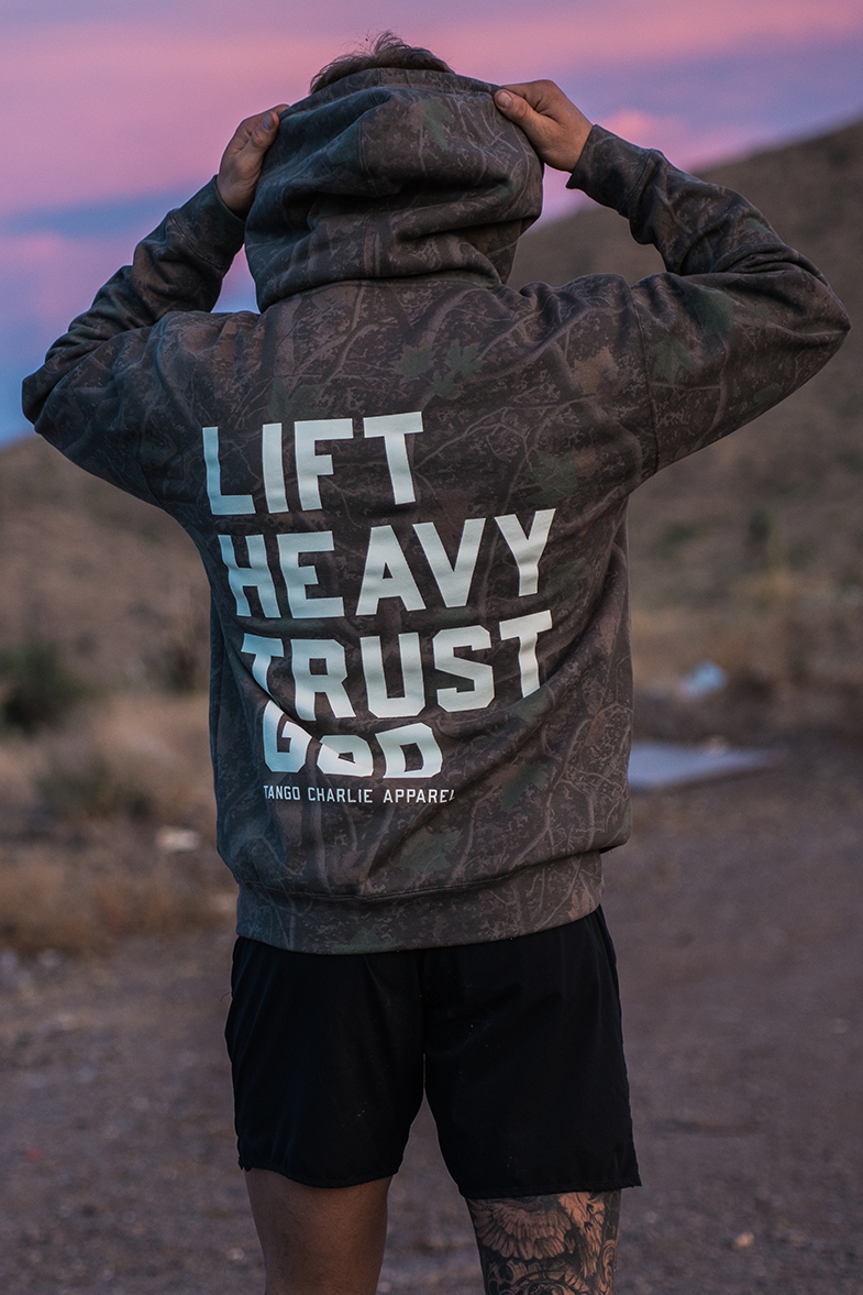 Lift Heavy. Trust God. - Premium Darkwood Camo Hoodie