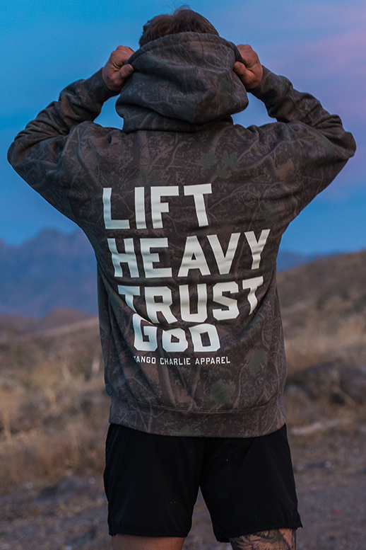 Lift Heavy. Trust God. - Premium Darkwood Camo Hoodie